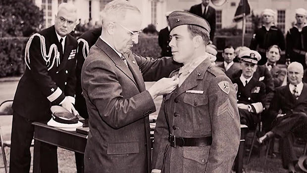 Truman places a medal around Williams' neck during a ceremony 