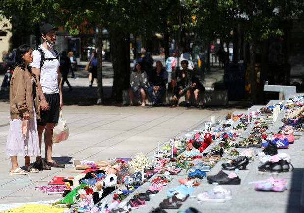 215 pairs of children's shoes set up in Vancouver as tribute after residential school discovery 