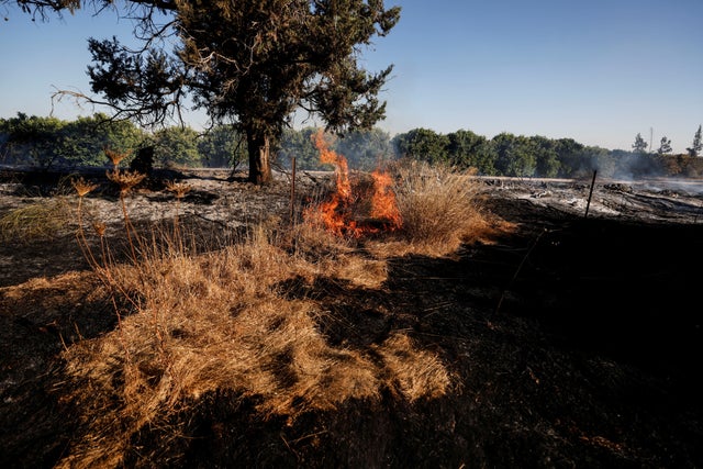 A field on fire is seen after Palestinians in Gaza sent incendiary balloons over the border between Gaza and Israel, Near Nir Am 