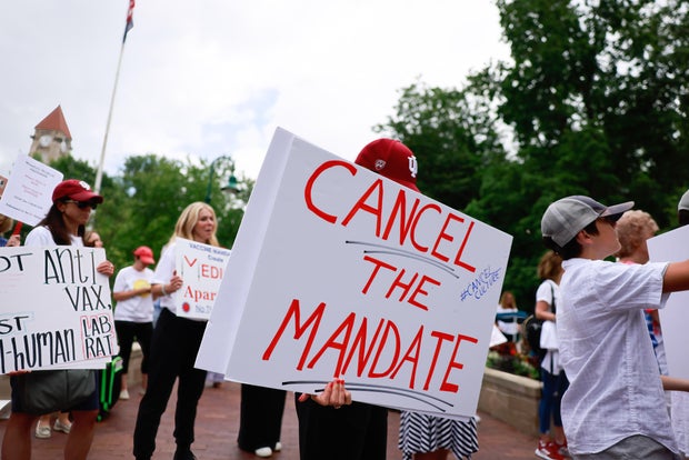 Protesters holding placards gather at Indiana University's