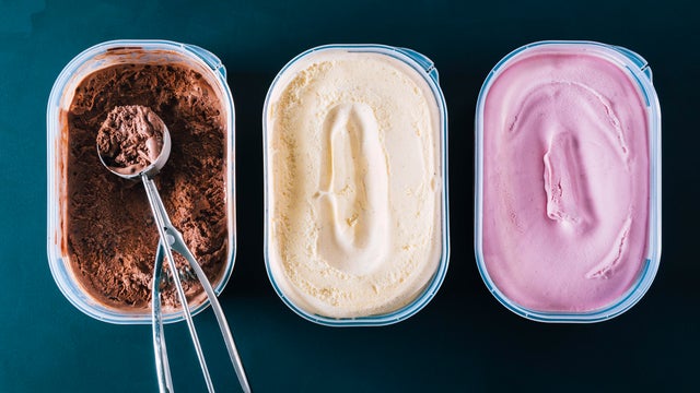 Chocolate, vanilla and strawberry ice cream tubs with scoop 