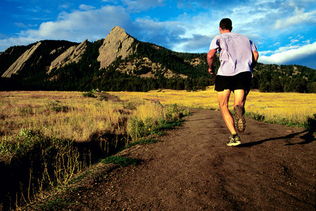 Colorado, Boulder, Man Running On The Chatauqua Meadow Trail, With Green Mountain And Flatirons In Background. 