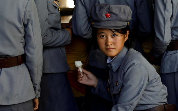 FILE PHOTO: Soldier eats ice cream as she visits a zoo in Pyongyang 