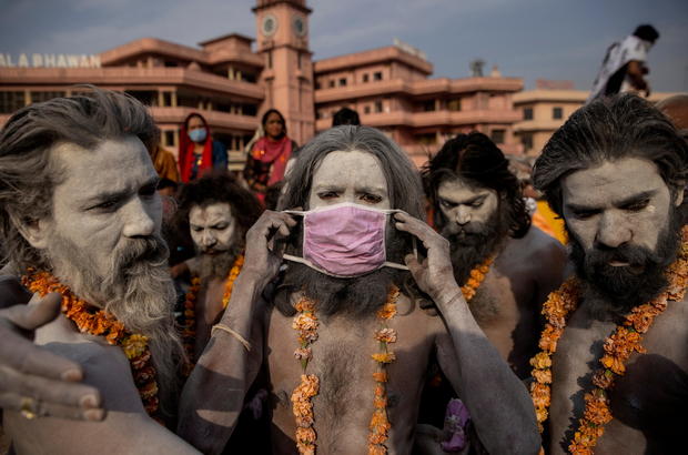 FILE PHOTO: A Naga Sadhu, or Hindu holy man wears a mask before the procession for taking a dip in the Ganges river during Shahi Snan at "Kumbh Mela", or the Pitcher Festival, amidst the spread of the coronavirus disease (COVID-19), in Haridwar 