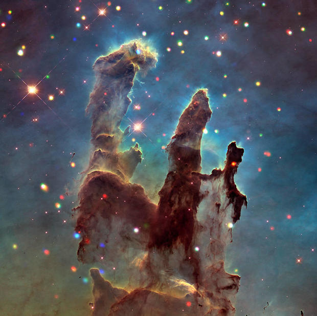 Elephant trunks of interstellar gas and dust in the Eagle Nebula. 