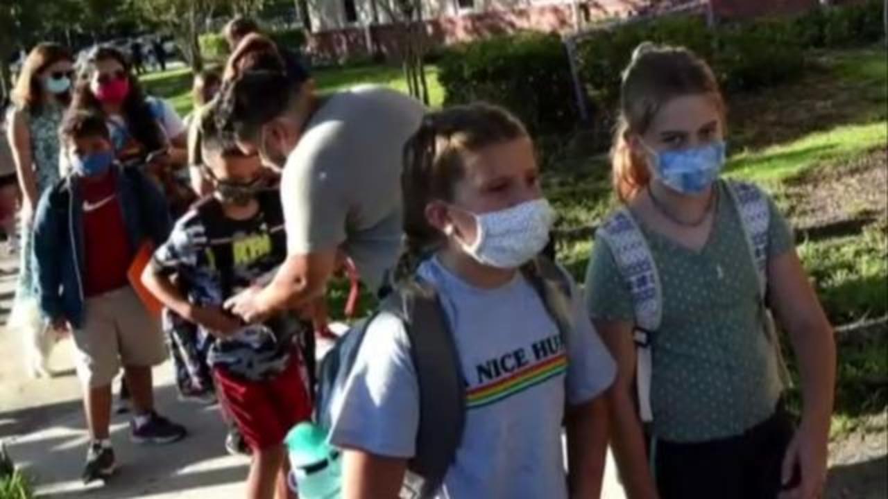 School mask debate rages in Florida as COVID cases surge - CBS News