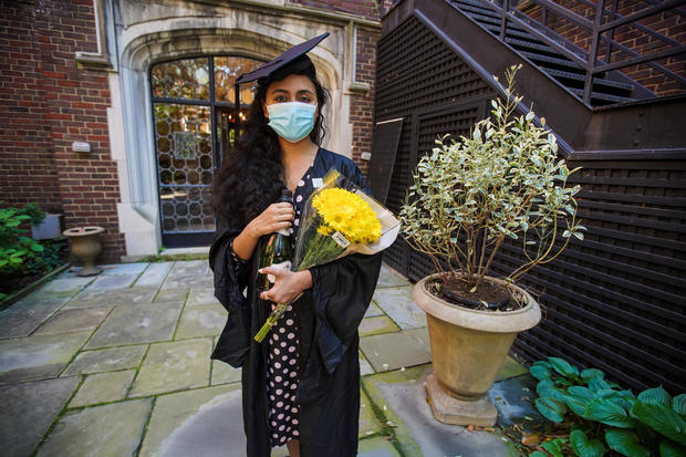 Pakistani student Varsha Thebo, 27, poses on the campus of the International Student House where she resides, on the day of her graduation from Georgetown University in Washington, DC on May 15, 2020. - Varsha studied Global Human Development, her graduation ceremony was cancelled due to the coronavirus pandemic, so she is celebrating online instead. 