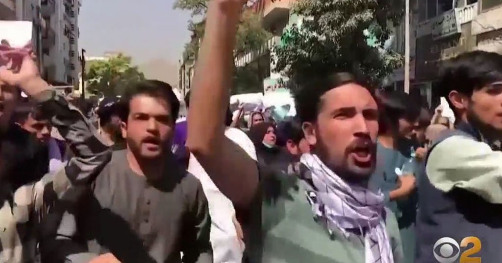 Taliban Faces Defiant Protests As 'Around 100' Americans Await Escape ...