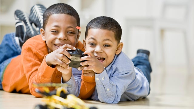Brothers playing with remote control car 