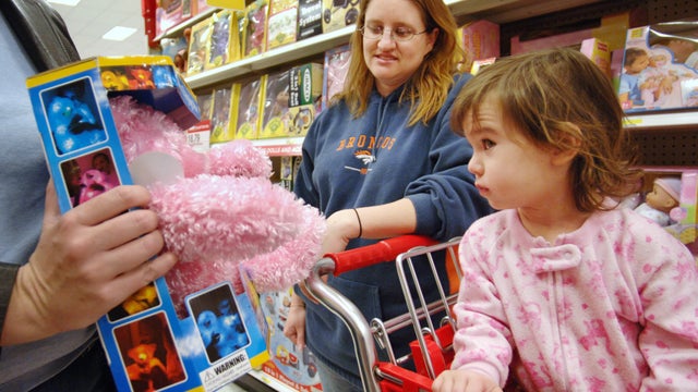 Sadie Cole, 21 months old, looks at a toy her mom Danielle C 