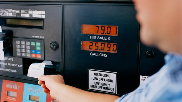 Man getting receipt from gas pump 