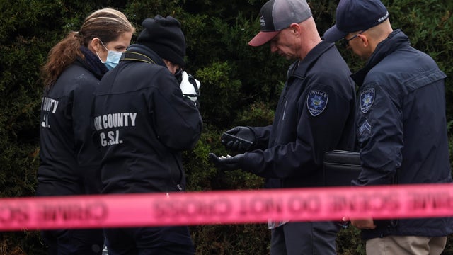 Law enforcement officers collect evidence near the scene of a shooting at the Boise Towne Square shopping mall in Boise, Idaho 