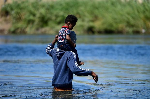 Haitian immigrants crossing the Rio Grande river 