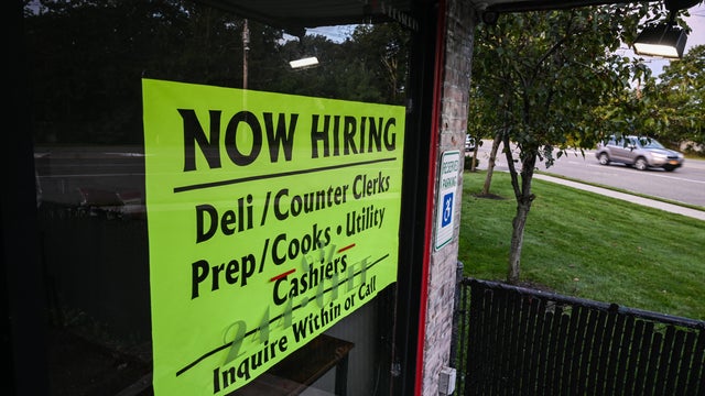 Help wanted sign posted on the window of a Long Island takeout eatery 
