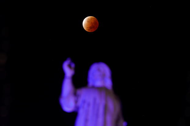 A shadow falls on the moon as it undergoes a partial lunar eclipse as seen from San Salvador 