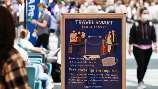 A sign advising travelers of the requirements for social 