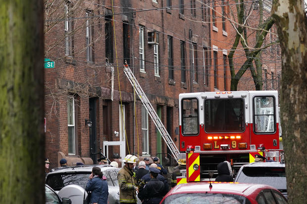 Philadelphia firefighters work at the scene of a deadly rowhouse fire January 5, 2022, in the Fairmount neighborhood of Philadelphia. 