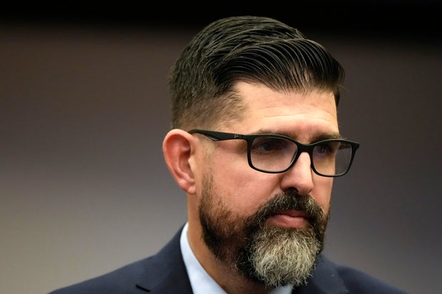 Florida state Senator Manny Diaz Jr. walks in the Senate chamber following the opening of a special legislative session targeting COVID-19 vaccine mandates, November 15, 2021, in Tallahassee, Florida.
