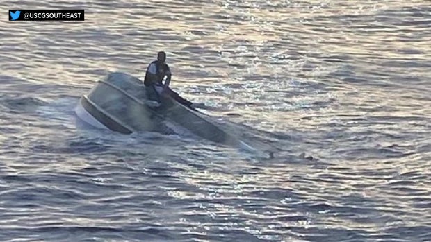 man on a capsized vessel USCG pic
