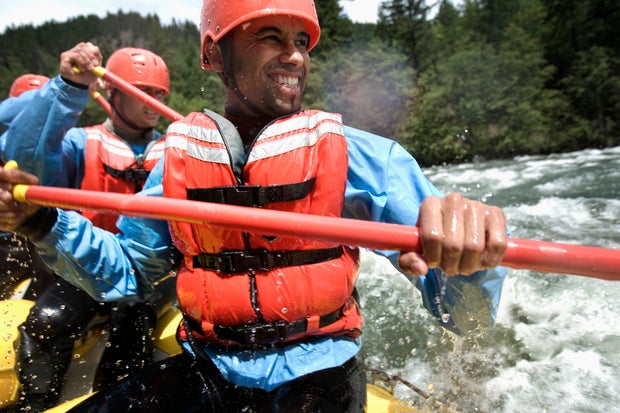 Group of Men Whitewater Rafting 