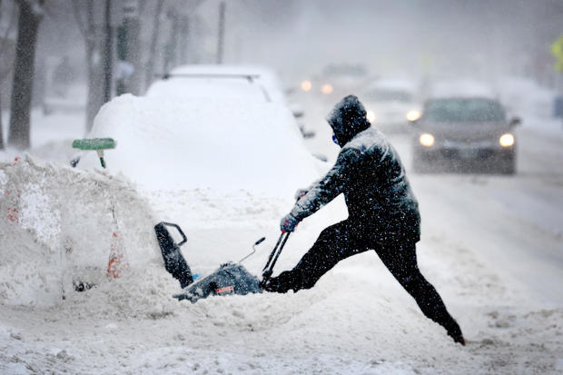 A resident digs out his car on February 2, 2022, in Chicago, Illinois. 