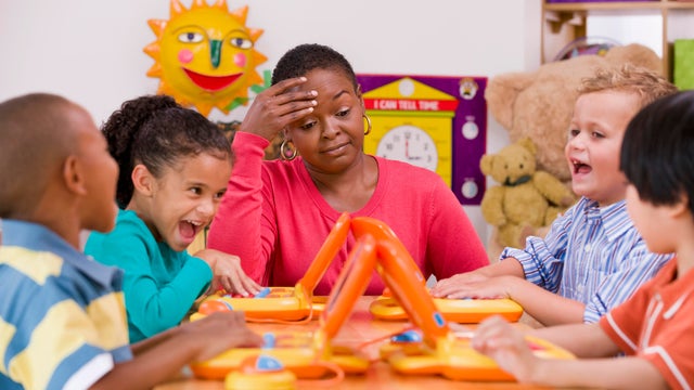 Children playing with toy laptops in class 
