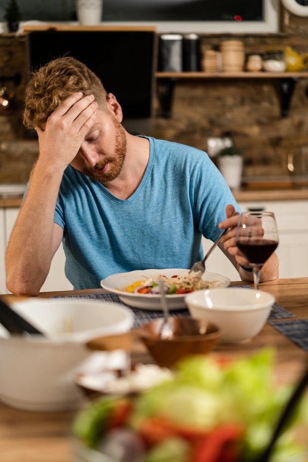 eating disorder anorexia Depressed young man having no appetite to eat. 