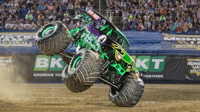Weston Anderson closes the driver's side door on his monster truck, Grave Digger.