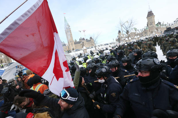 Protesters from the "Freedom Convoy" in Ottawa are moved from Wellington Street in front of Parliament Hill by police officers after blockading the the downtown core of Canada's capitol for over three weeks. 