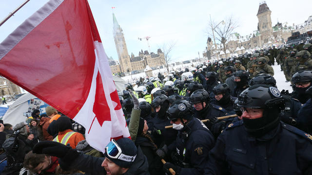 Protesters from the "Freedom Convoy" in Ottawa are moved from Wellington Street in front of Parliament Hill by police officers after blockading the the downtown core of Canada's capitol for over three weeks. 