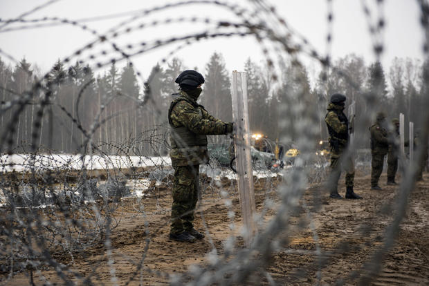 Armed border guards are seen guarding the border line with 