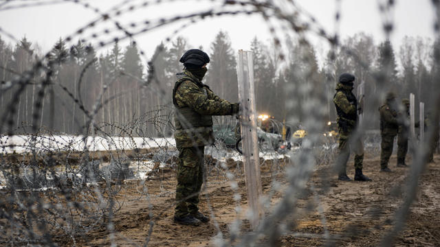 Armed border guards are seen guarding the border line with 