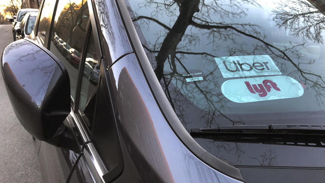 Uber and Lyft sign in windshield of car, Queens, New York 