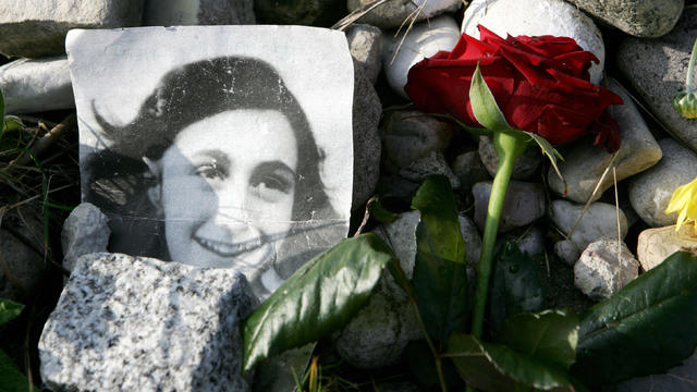 A picture of Anne Frank lies in front of 