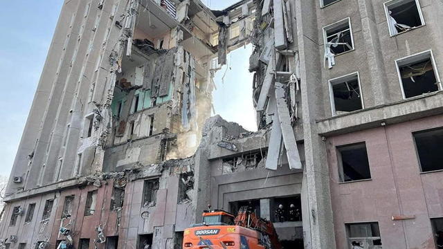 Rescuers work at the site of the regional administration building hit by cruise missiles, in Mykolaiv 