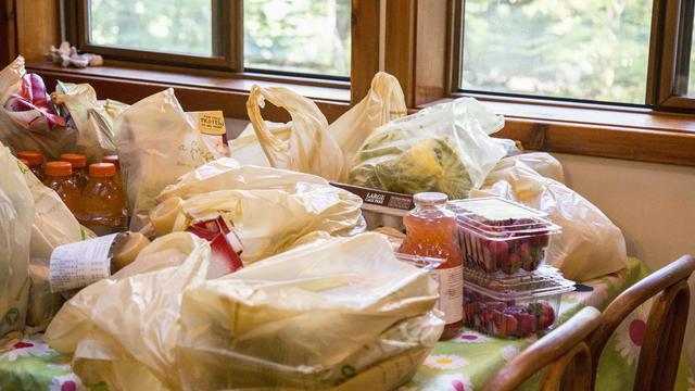 Bags of groceries on dining room table 