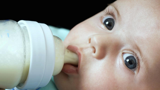 A baby drinking from a bottle 