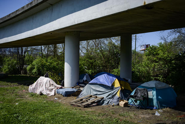 Multiple tents rest underneath an overpass in East Nashville. 