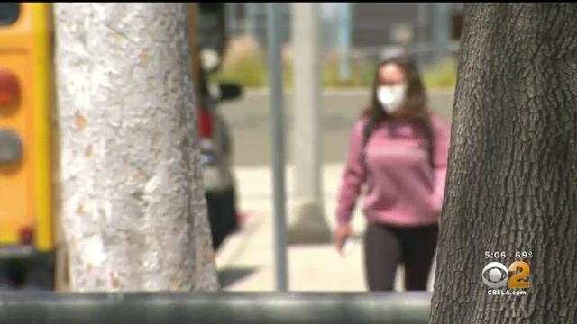 Concept of Covid-19 quarantine or lockdown end. Close up of happy woman taking off her face mask. 