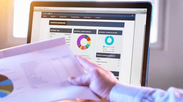 Man viewing online portfolio of investments for savings and pension 