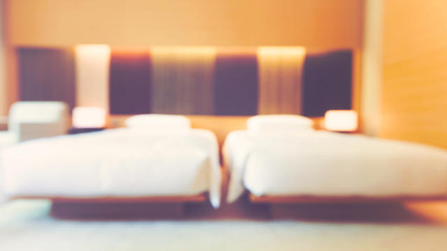 blurred-luxury-hotel-room-with-two-queen-beds-SBI-310532059.jpg 