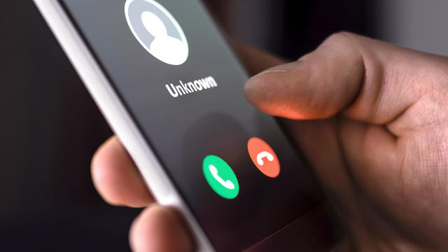 person rejecting call from unknown caller or unknown number on smartphone 