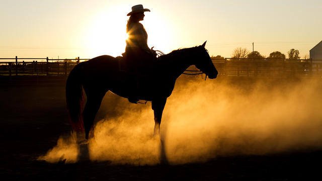 Woman on horse at sunset 