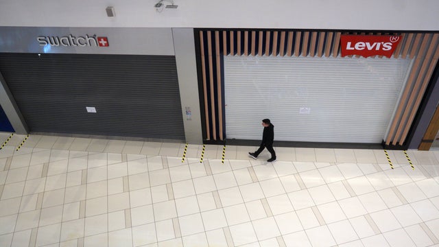 Man walking through empty mall 