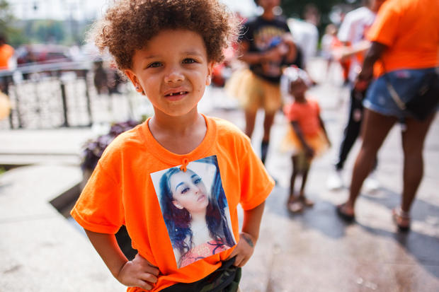 Prynce Brunner, 4, stands with a picture of his mother, Mia 