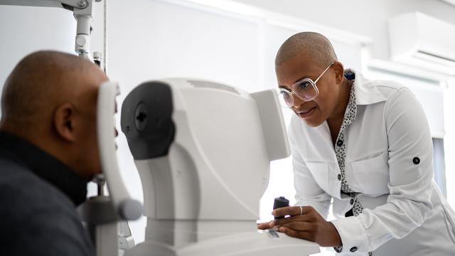 Ophthalmologist examining patient's eyes 