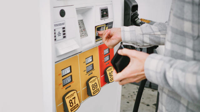 Man Purchases Gas at Pump 