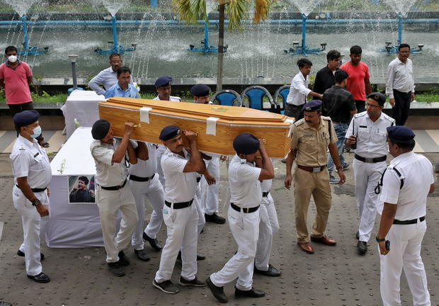 Police officers carry the coffin containing body of Indian singer KK after a gun salute in Kolkata 