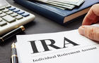 Documents about Individual retirement account IRA on a desk. 