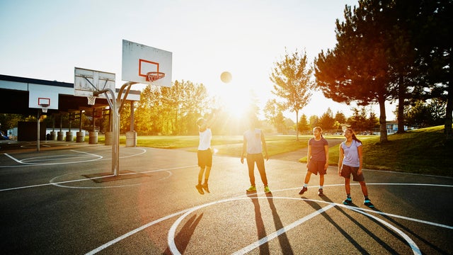 Father helping daughters with shoot jump shots 